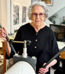 Sheila Sondik in her studio with her printing press